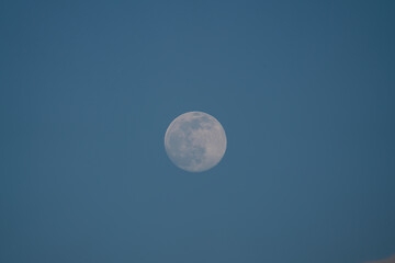 Wall Mural - Big Moon with some clouds and blue sky at the afternoon
