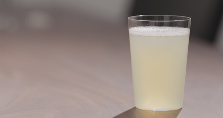 Wall Mural - ginger beer into tumbler glass on walnut table