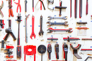 Front of layout tools of technician on white wooden board. Repair equipment and many handy tools. Repair tool kit.