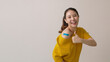 © ChayTee - Young attractive beautiful asia female or teenage receive covid-19 anti virus vaccine in campaign vaccination safe life happy smile cheerful with blue, yellow, pink bandage on arm with copy space.