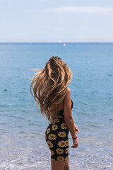 Wall Mural - Blonde woman enjoying holidays in the beach