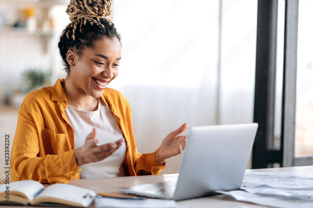 Online communication. Confident joyful beautiful african american young female student or freelancer with afro dreadlocks, study remotely, talks by online conference with coworkers or teacher, smile - obrazy, fototapety, plakaty 