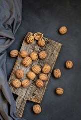 Wall Mural - Ripe and raw whole big walnut kernel with shell on rustic backdrop. healthy nut food for brain