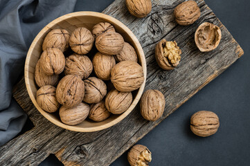 Wall Mural - Ripe and raw whole big walnut kernel with shell on rustic backdrop. healthy nut food for brain