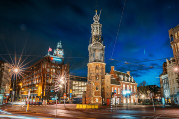 Munttoren or Mint Tower or Munt in Amsterdam historical center at night, Netherlands.