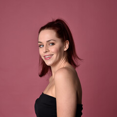 Sticker - Close up portrait of a red haired woman with expressive facial features on a pink studio background.