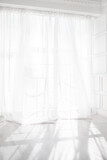 Fototapeta  - Backlit window with white curtains in empty room