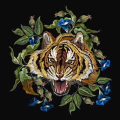 Wall Mural - Embroidery tiger head and beautiful blue flowers. Wild animals art. Fashionable template for design of clothes, t-shirt design