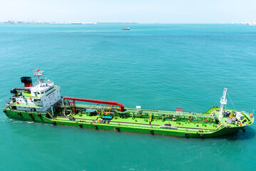 Port of Singapore, bunker barge on her way to supply fuel oil to large container vessels. 