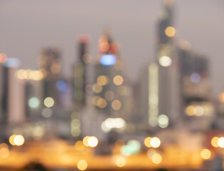 Wall Mural - Blurred sunset bokeh lights city office building, abstract background.