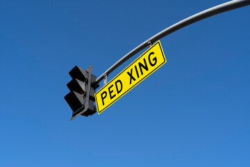 ped xing sign in a blue sky background