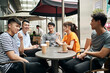 © imtmphoto - young asian adults relaxing at outdoor coffee shop
