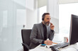© Yaroslav Astakhov - Happy matured man with headphones is sitting in a light white office