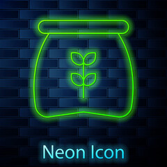 Poster - Glowing neon line Bag of flour icon isolated on brick wall background. Vector