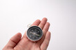 © epovdima - Black compass in hando n the white background