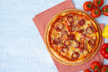 Delicious pizza with sausages on gray background