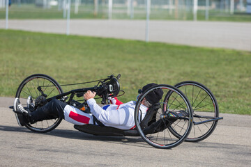 Wall Mural - Senior Athlete training with His Hand Bike on a Track