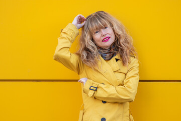 Wall Mural - portrait of adult woman on the yellow wall