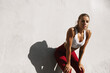 © Liubov Levytska - Sweaty fitness girl taking breath on morning jogging. Female athlete runner resting, workout outdoors on fresh air, jogger take break, wearing sports outfit, standing near concrete wall