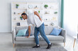 © Prostock-studio - Millennial African American guy suffering from back pain, leaning on sofa, cannot walk at home. Healthcare concept