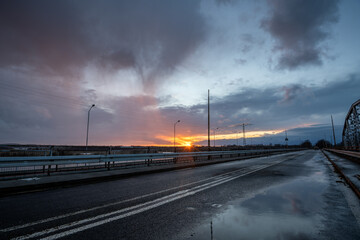 Wall Mural - stormy sunset over the road bridge