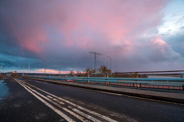 Wall Mural - stormy sunset over the road bridge