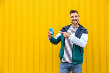 Wall Mural - Handsome man with soda on color background