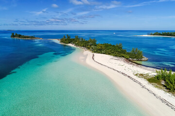 Aerial view of Munjack Cay with bay and beach in Abaco, Bahamas. Green turtles and stingrays inhabit the area.