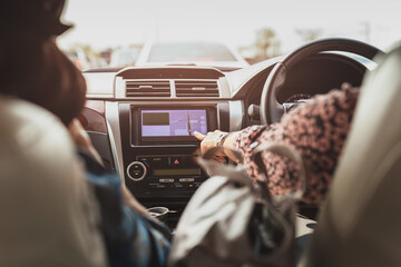 Wall Mural - Woman finger touching a touch screen navigation on car dashboard.