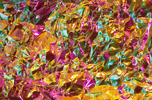 Gold Texture Effect With Pink And Green Multicolor Tint. Futuristic Chrome Abstract Crumled Foil Paper. Honey Gold And Juicy Pink Fusion Colors Background With Rough Crumpled Structure.