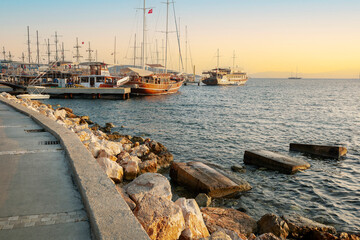 Wall Mural - Stylish luxury yachts, ships and sailing boats moored on Bodrum Marina, Turkey, on the sunset.