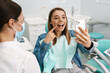 © Drobot Dean - Happy young woman taking a selfie during medical checkup