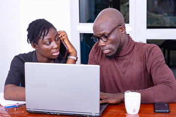 two serious business partners working together on laptop in the office.