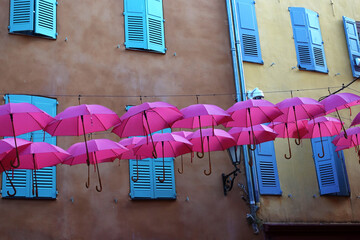 colorful houses with umbrellas in town of Provence