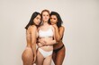 © Ivan - Photo of optimistic young women, multiracial friends wear underwear, hug each other and show their love. Concept natural beauty and girl power