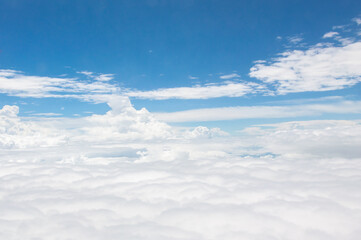 Wall Mural - over the clouds,Blue sky with tiny clouds background Beautiful natural view from airplane window above. Background or Wallpaper.blue sky and cloud sky nature.Top view of aircraft