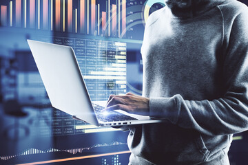 Cyberspace and stats data concept with guy in hoody working on laptop and virtual screen with data graphs
