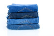 © CHARAN - stack of blue jeans on a white background