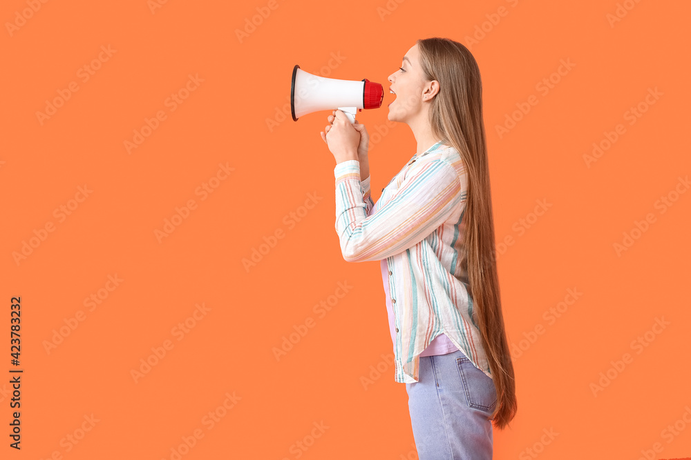 Young woman with megaphone on color background