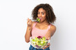 © luismolinero - Young  African American woman with salad isolated on white background