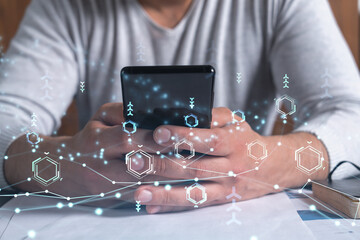 programmer holding in the hands a smart phone and testing an innovative application to provide a com