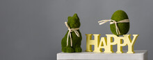 Easter Composition With Green Egg, Bunny And Wooden Inscription Happy On Gray Background, Place For Text