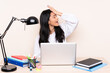 © luismolinero - Student asian girl in a workplace with a laptop isolated on beige background has realized something and intending the solution