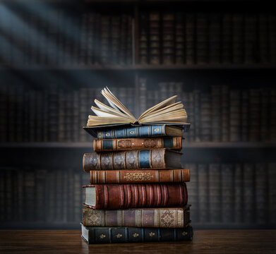 Wall Mural - A stack of old books on table against background of bookshelf in library. Ancient books as a symbol of knowledge, history, memory. Conceptual background on education, literature topics.