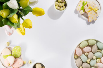 Sticker - Easter table setting with a plate of colored pastel eggs, a bouquet of tulips and biscuits rabbits,