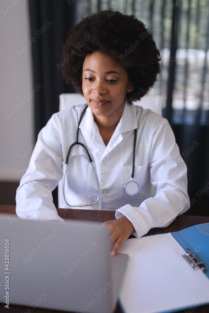 African american female doctor sitting making video call consultation - obrazy, fototapety, plakaty 