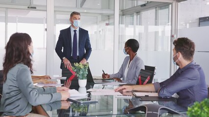 Wall Mural - Business people wearing mask and keeping social distancing during meeting