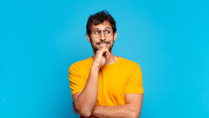 Wall Mural - young handsome indian man thinking expression