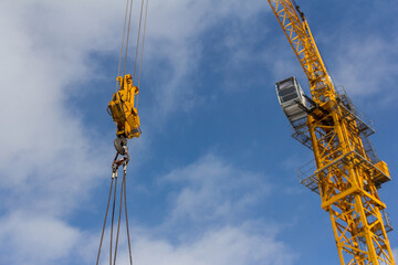 Poster - Tower crane against the blue sky. Construction equipment