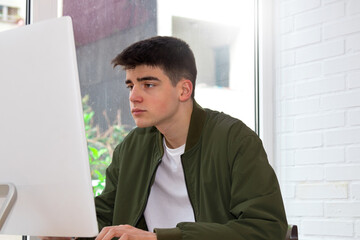 Sticker - teenage student working with computer at home